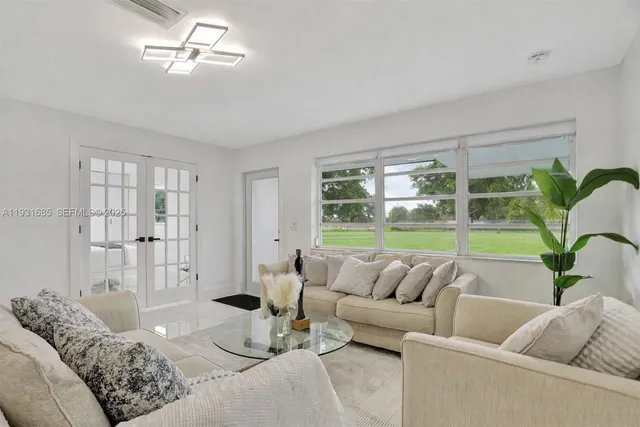 a living room with furniture and a large window