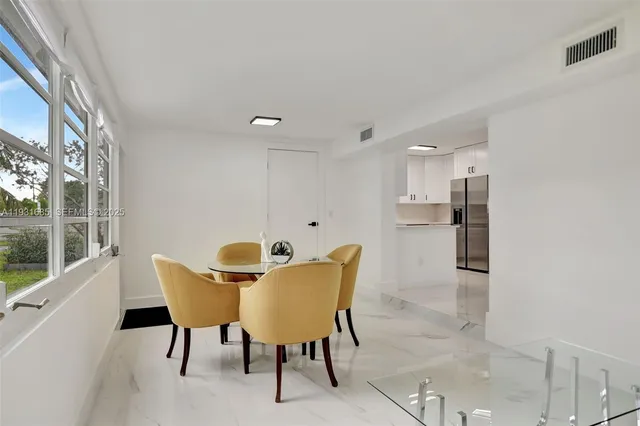 a view of a dining room with furniture and a window