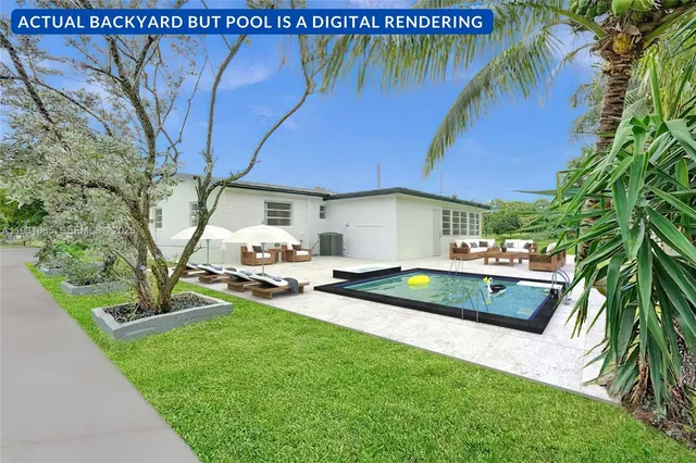 a view of a backyard with couches under an umbrella