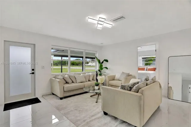 a living room with furniture and a large window