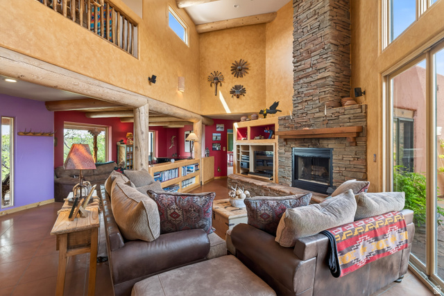3617 Red Rock Drive Moab, UT 84532 - Photo 22 of 79 Living area featuring healthy amount of natural light, a high ceiling, and a stone fireplace