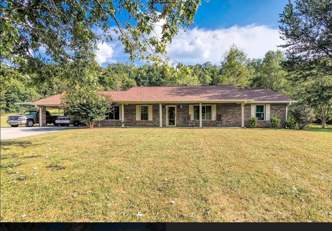 282 Little Tater Valley Road Luttrell, TN 37779 - Photo 1 of 26 a front view of a house with a garden
