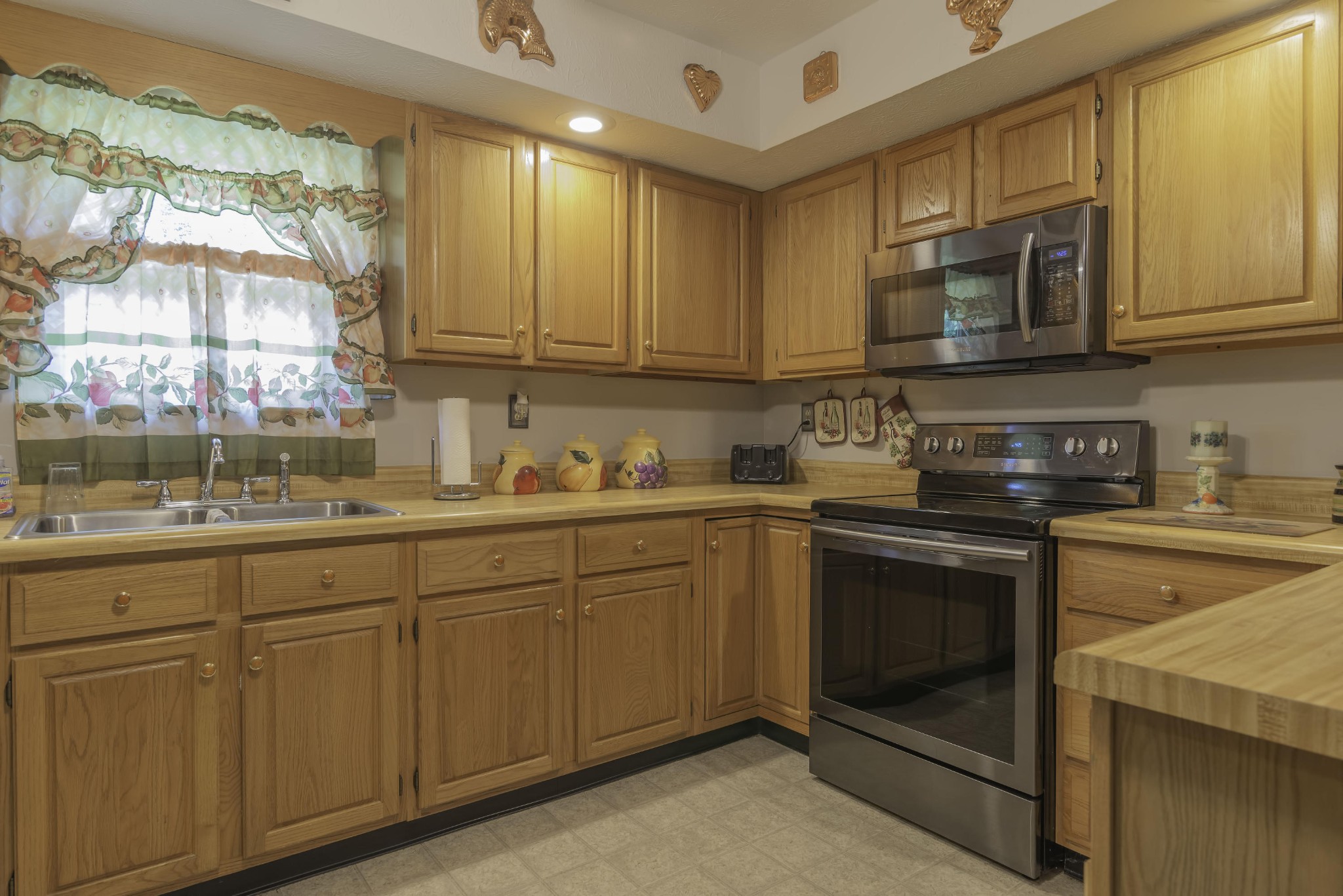 282 Little Tater Valley Road Luttrell, TN 37779 - Photo 9 of 26 a kitchen with stainless steel appliances granite countertop a stove a sink and a microwave