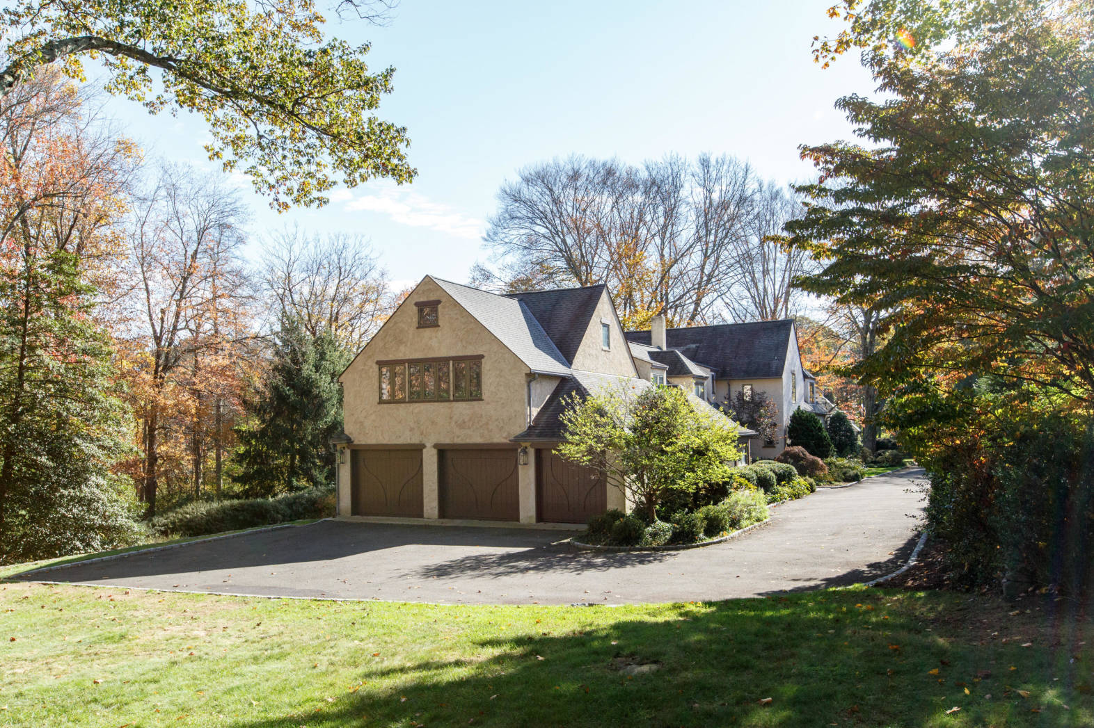 11 Meadowbrook Road Darien, CT 06820 - Photo 36 of 41 a front view of a house with a yard and garage