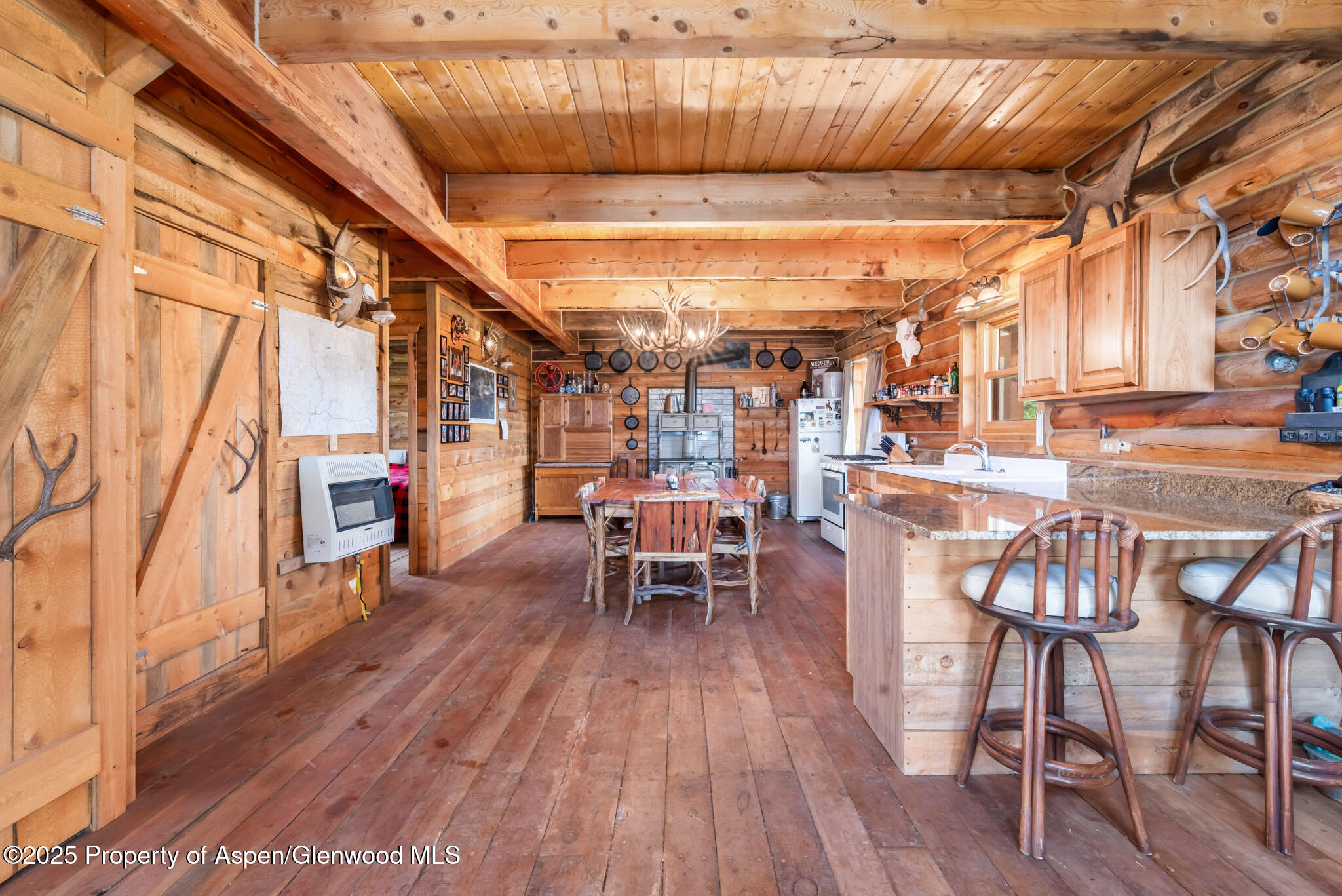 943 Routt Forest Drive Craig, CO 81625 - Photo 11 of 120 a dining room with furniture and wooden floor