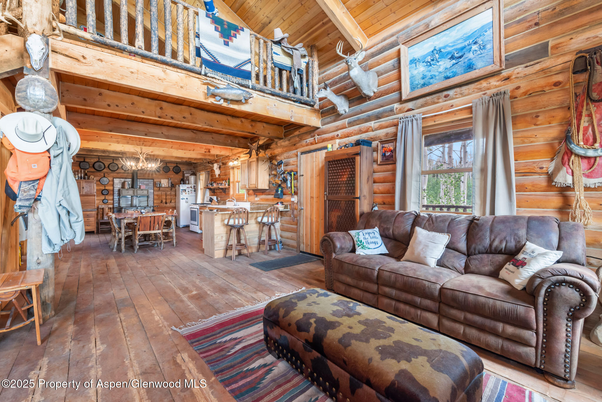 943 Routt Forest Drive Craig, CO 81625 - Photo 18 of 120 a living room with furniture a wooden floor and next to a window