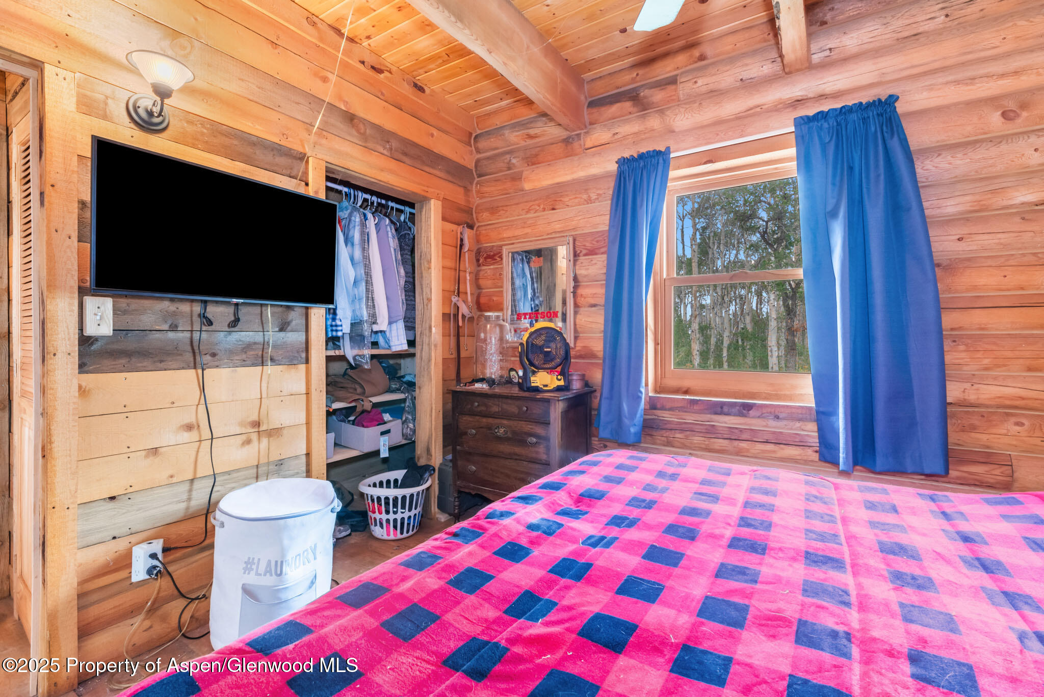 943 Routt Forest Drive Craig, CO 81625 - Photo 29 of 120 a bedroom with a bed and a flat tv screen