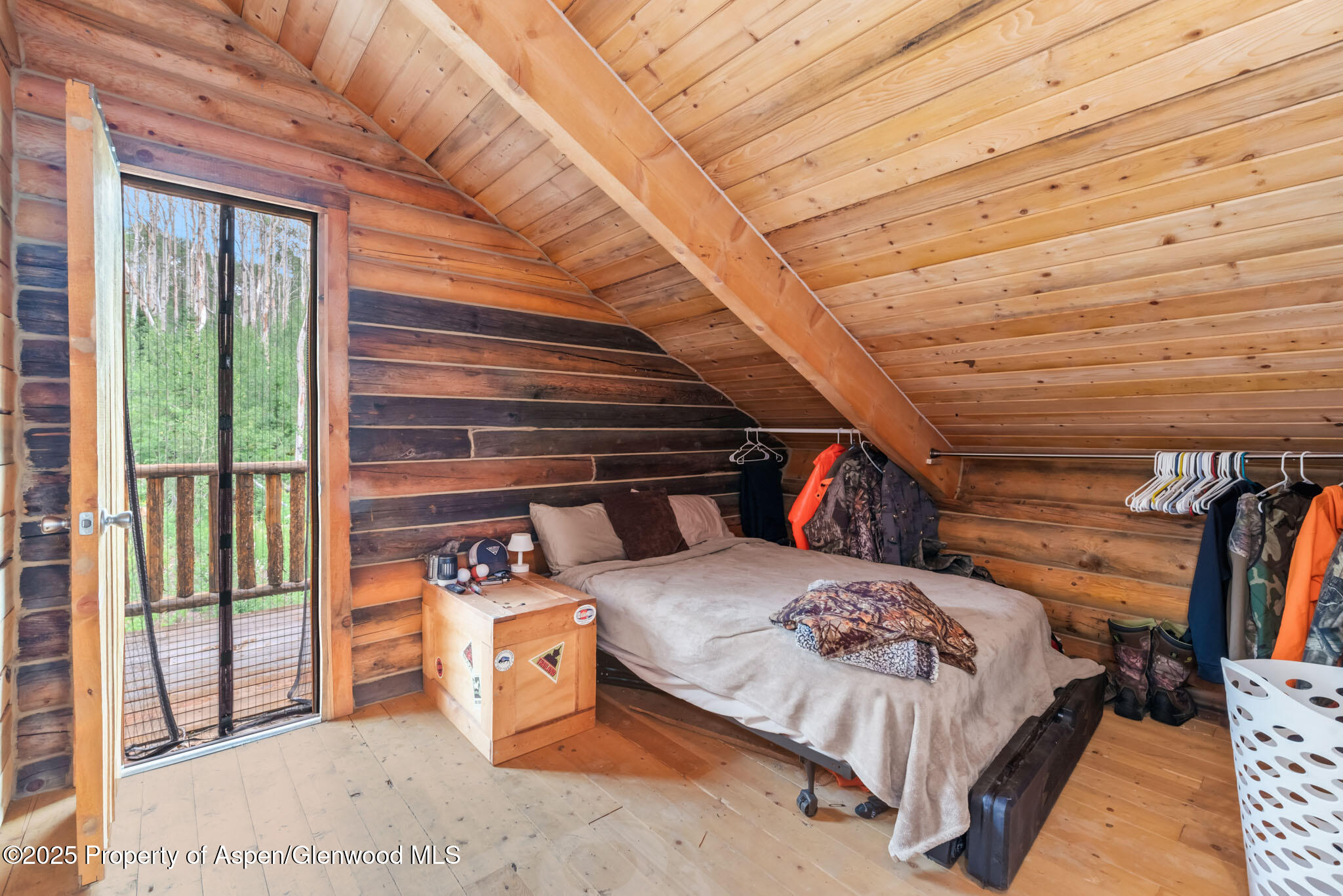 943 Routt Forest Drive Craig, CO 81625 - Photo 42 of 120 a bedroom with a bed next to a large window