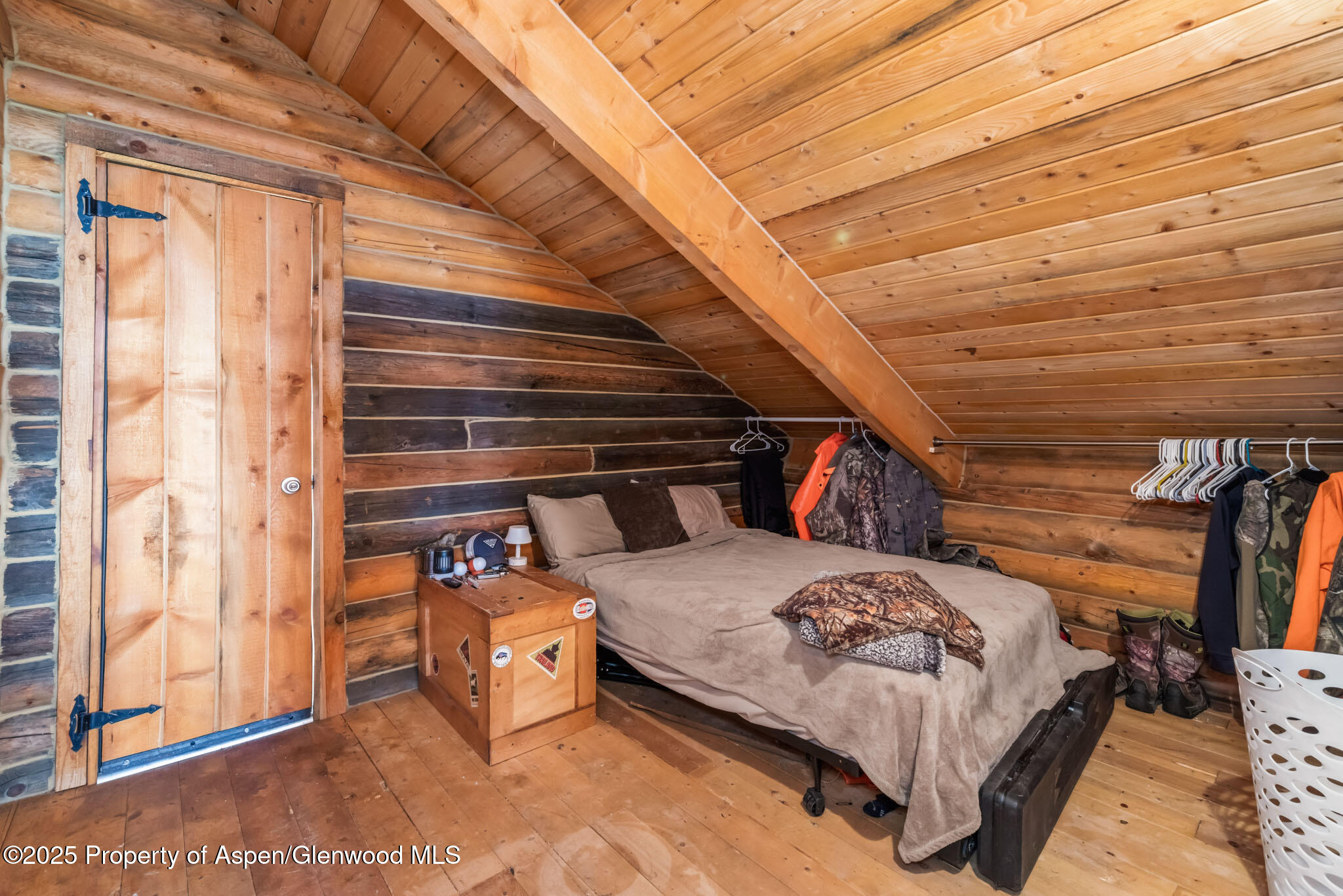 943 Routt Forest Drive Craig, CO 81625 - Photo 43 of 120 a bedroom with a bed and wooden floor