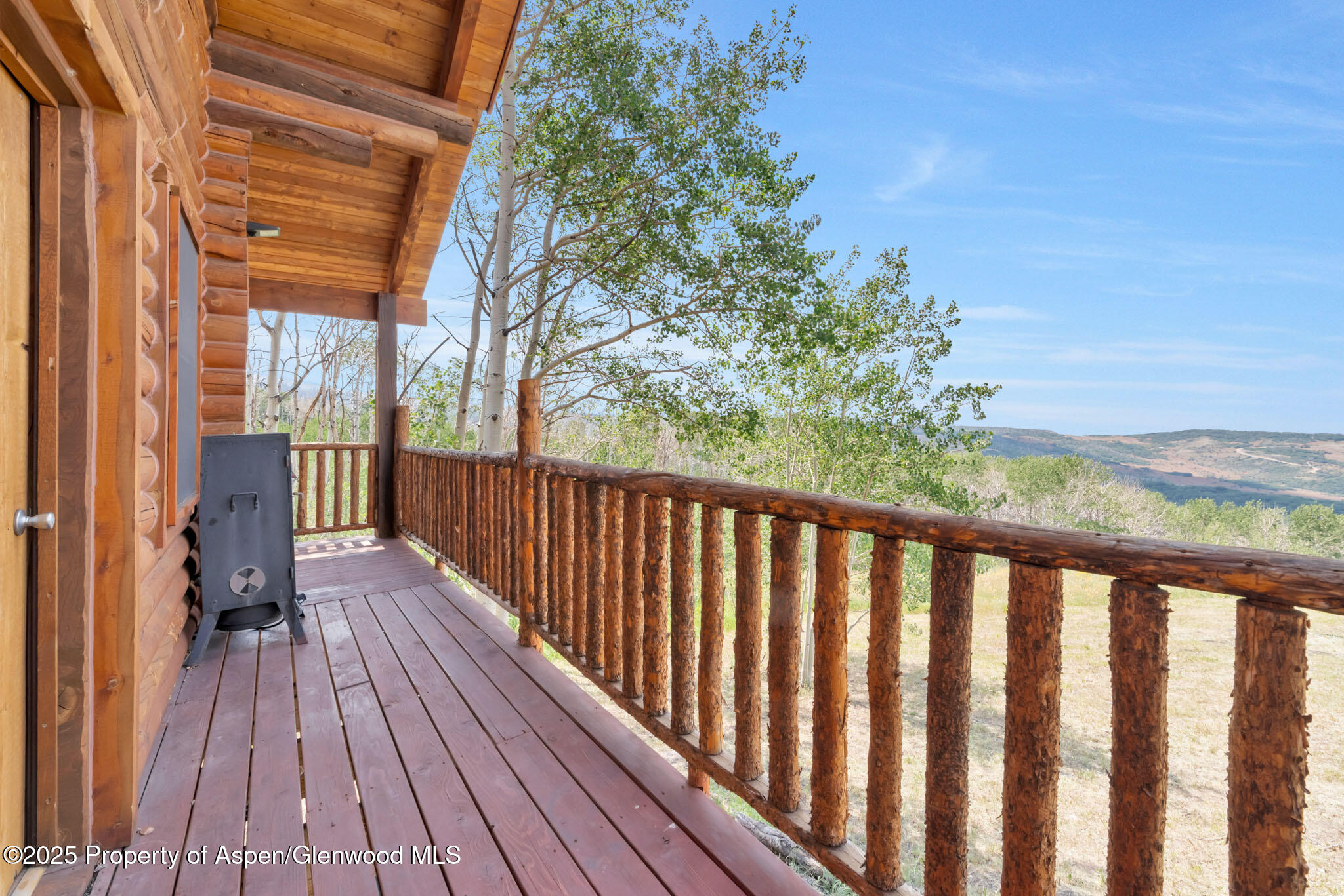 943 Routt Forest Drive Craig, CO 81625 - Photo 69 of 120 a balcony with wooden floor and fence