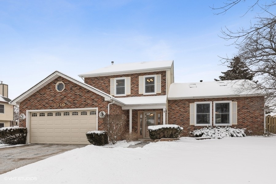 1310 Chatsworth Lane Hoffman Estates, IL 60169 - Photo 1 of 18 a view of a house with snow on the road