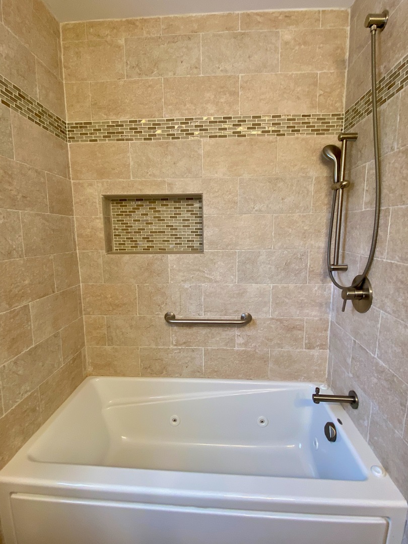 1310 Chatsworth Lane Hoffman Estates, IL 60169 - Photo 12 of 18 a bathroom with a shower and a bath tub