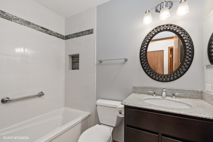 1310 Chatsworth Lane Hoffman Estates, IL 60169 - Photo 15 of 18 a bathroom with a sink and a mirror