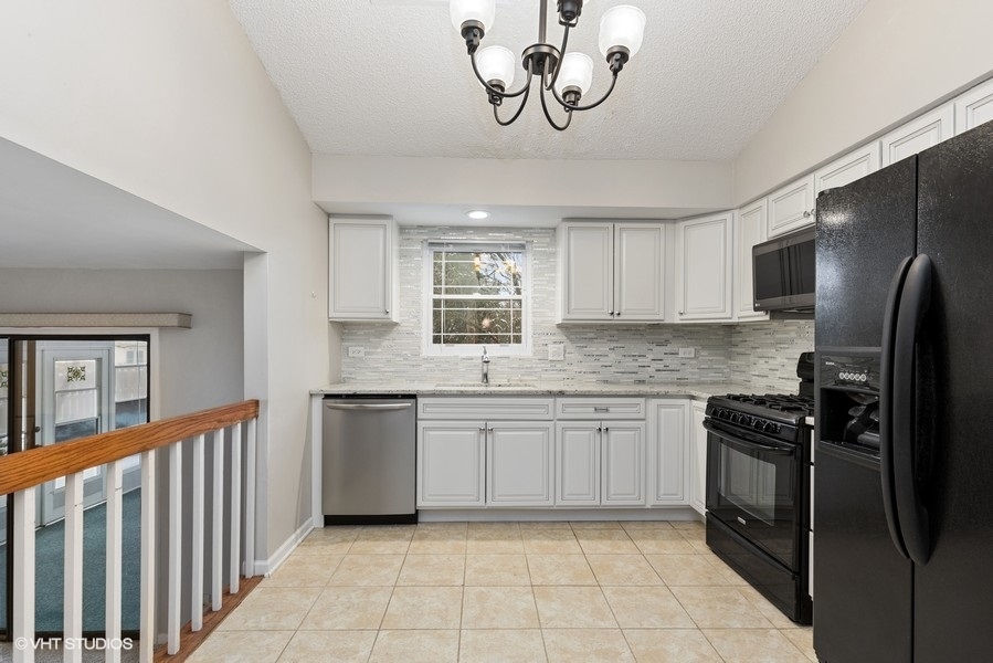 1310 Chatsworth Lane Hoffman Estates, IL 60169 - Photo 6 of 18 a kitchen with a refrigerator and a sink