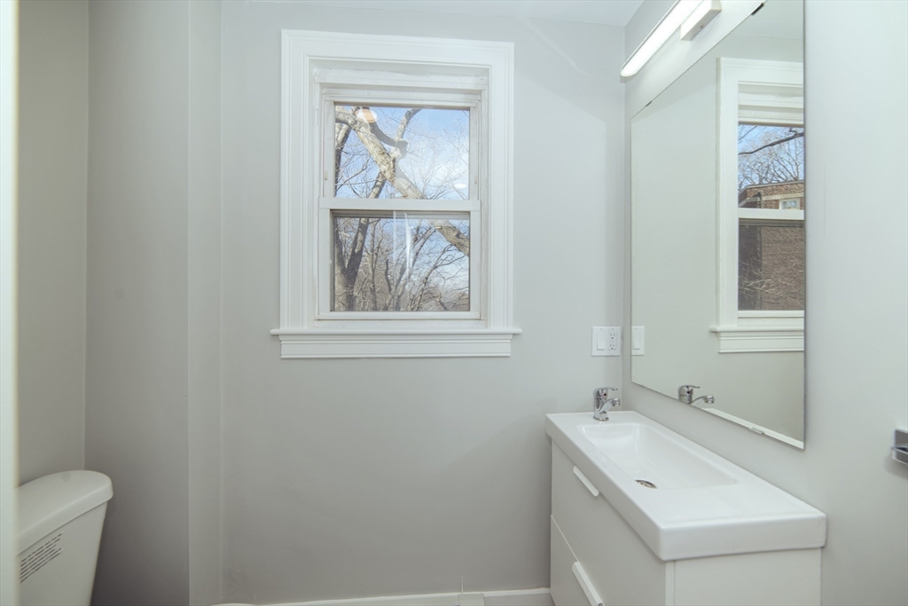 10 Duffley Court, Unit 1 Brookline, MA 02467 - Photo 11 of 23 a view of bathroom with a sink and mirror