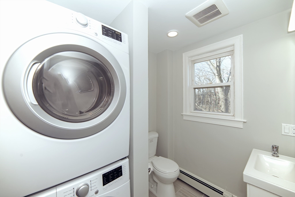 10 Duffley Court, Unit 1 Brookline, MA 02467 - Photo 12 of 23 a bathroom with a toilet a sink and a window