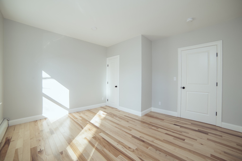 10 Duffley Court, Unit 1 Brookline, MA 02467 - Photo 14 of 23 a view of a room with wooden floor