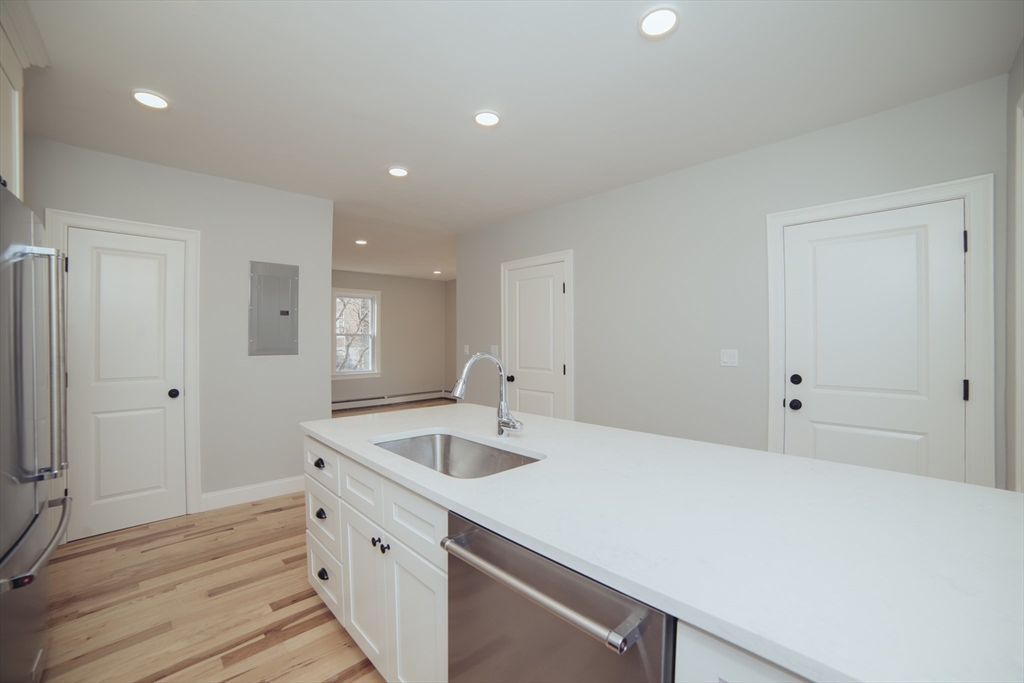 10 Duffley Court, Unit 1 Brookline, MA 02467 - Photo 2 of 23 a kitchen with a sink and cabinets