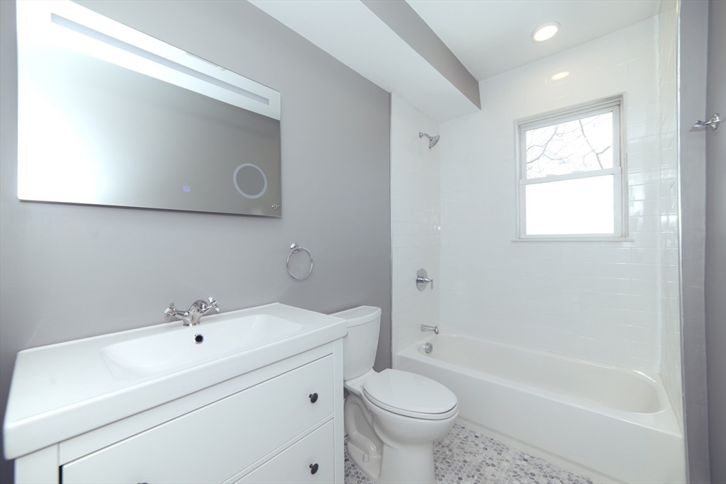 10 Duffley Court, Unit 1 Brookline, MA 02467 - Photo 10 of 23 a bathroom with a sink a toilet and bathtub
