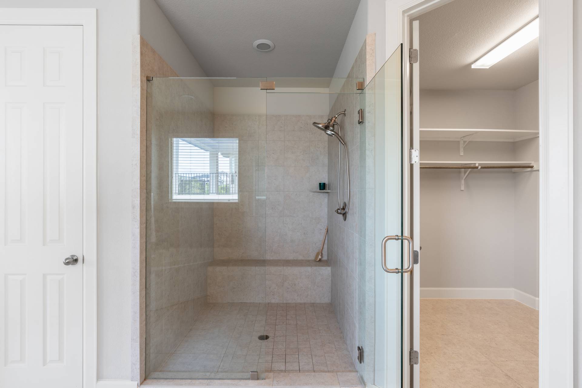 3516 Venezia View Leander, TX 78641 - Photo 31 of 40 Full bathroom with a stall shower, a spacious closet, and light tile patterned floors