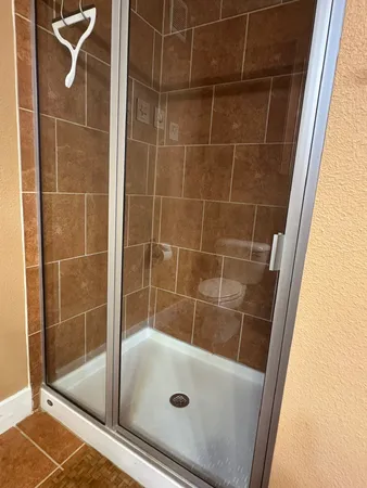a bathroom with a glass shower door
