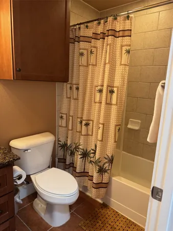 a bathroom with a toilet and shower