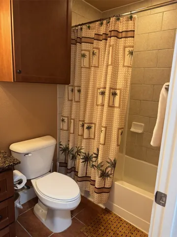 a bathroom with a toilet and shower