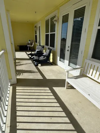 a view of a balcony with chair and wooden floor