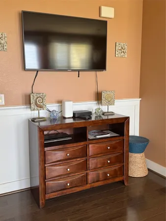 a room with a furniture and flat screen tv