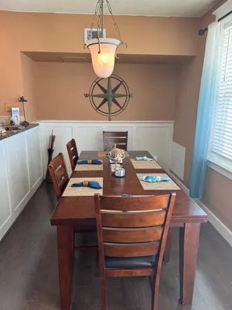 a room with a table chairs and a window