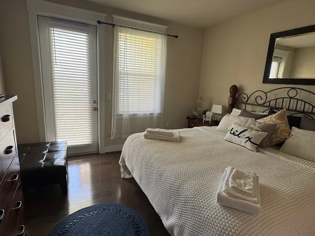 a bedroom with a bed and wooden floor