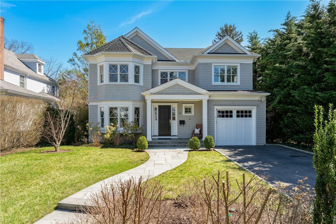 a front view of a house with a yard and porch