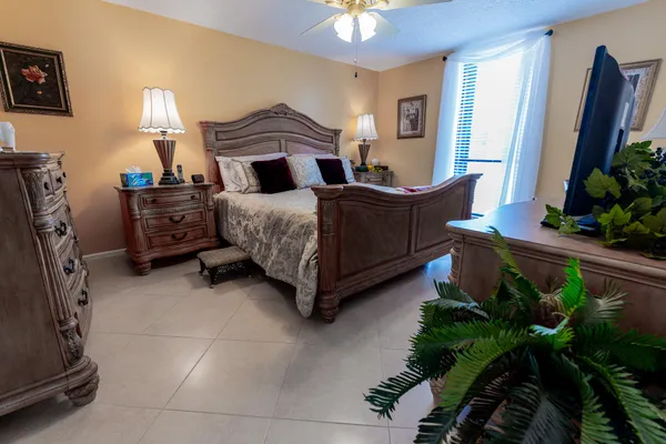 a bedroom with furniture and a flat screen tv