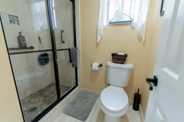 a white toilet sitting next to a sink
