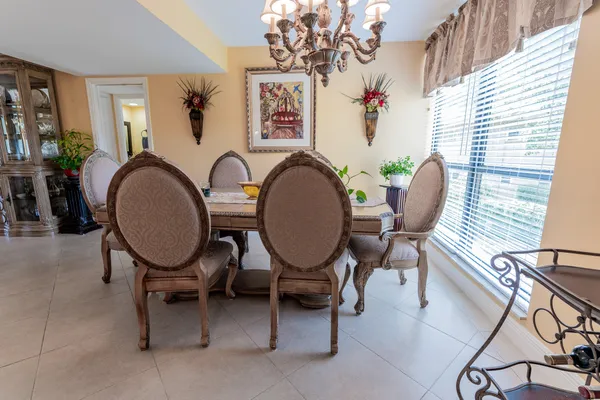 a living room with furniture a table and paintings on the wall