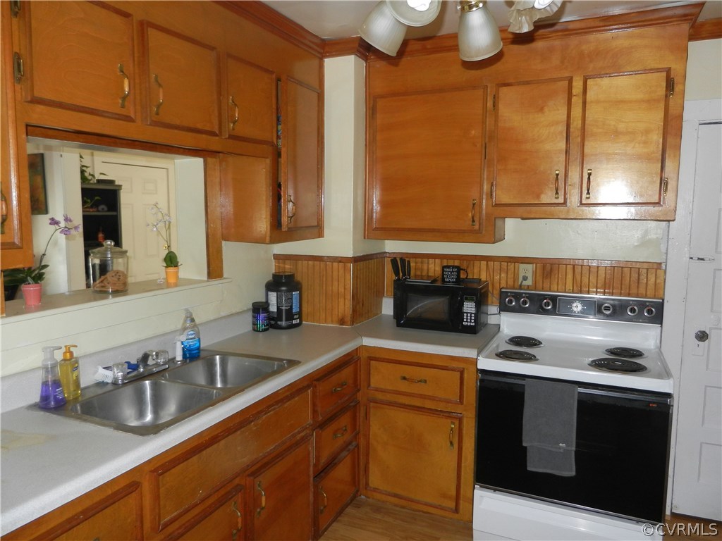 1007 Burnside Street Hopewell, VA 23860 - Photo 3 of 19 a kitchen with stainless steel appliances granite countertop a sink a stove and a microwave