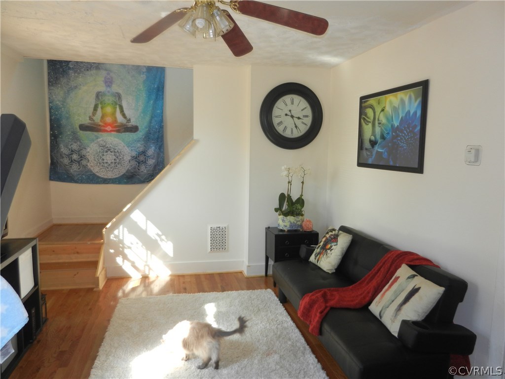 1007 Burnside Street Hopewell, VA 23860 - Photo 7 of 19 a living room with furniture and a clock