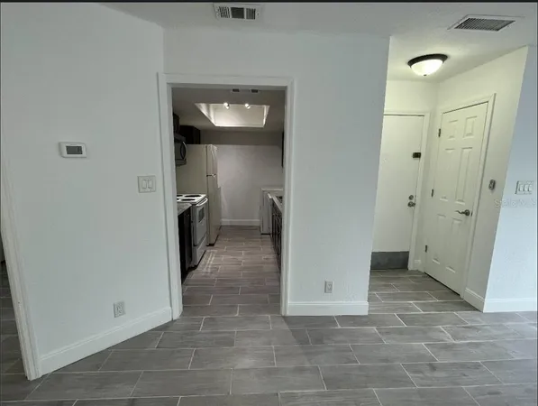 a view of a hallway with wooden shelves