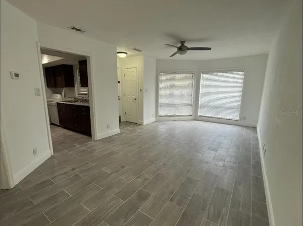 an empty room with a kitchen and a sink