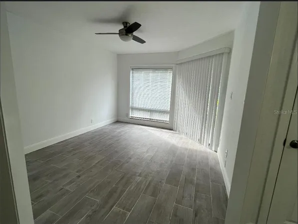 a view of an empty room with a window