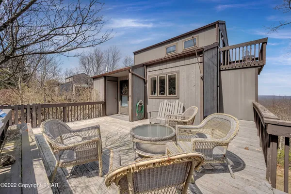 a table and chairs in front of a house