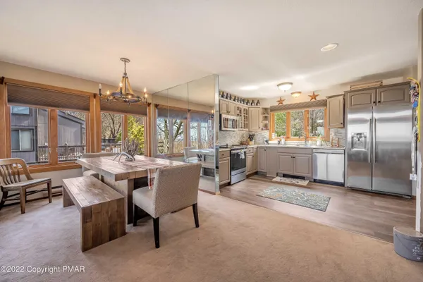a room with stainless steel appliances kitchen island granite countertop furniture and a kitchen view