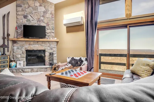a bedroom with furniture and a large window