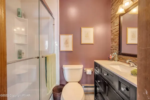 a bedroom with a bed and a large mirror on the dresser