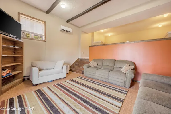 a bedroom with two beds and painting on the wall