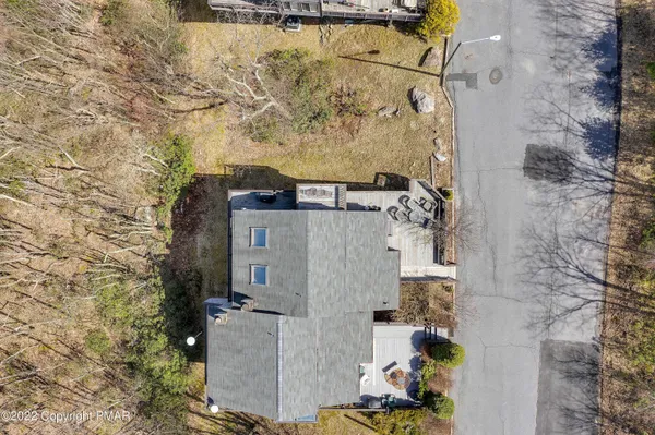 a aerial view of a house with a yard and seating space