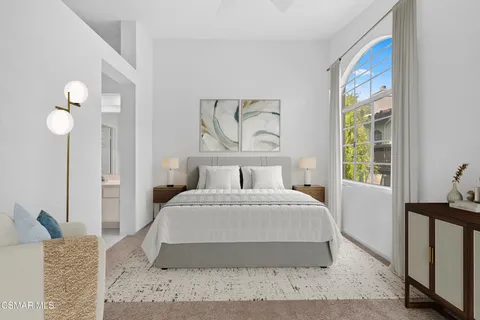 a bedroom with a large bed and a window