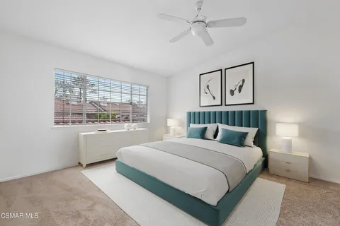 a bedroom with a large bed and a large window