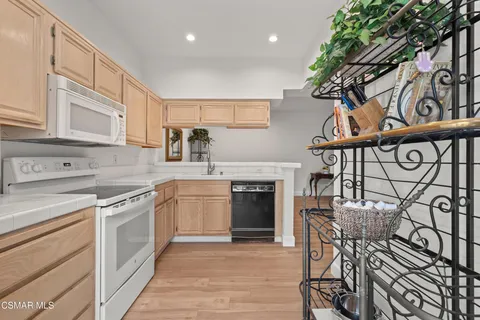 a kitchen with stainless steel appliances granite countertop a stove and cabinets