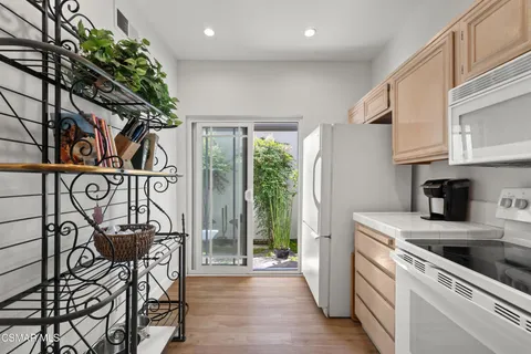 a kitchen with stainless steel appliances granite countertop a refrigerator and a stove top oven